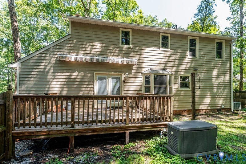 9007 Chatham Grove Lane, Richmond, VA 23236 Expansive wood deck with a bay window, double door access, and a retractable awning
