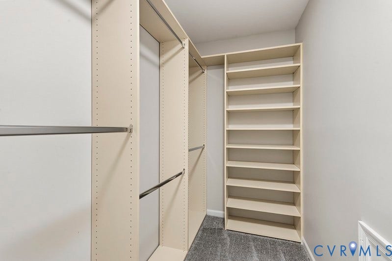 9007 Chatham Grove Lane, Richmond, VA 23236 Primary Bedroom Custom closet system with multiple shelving units and hanging rods