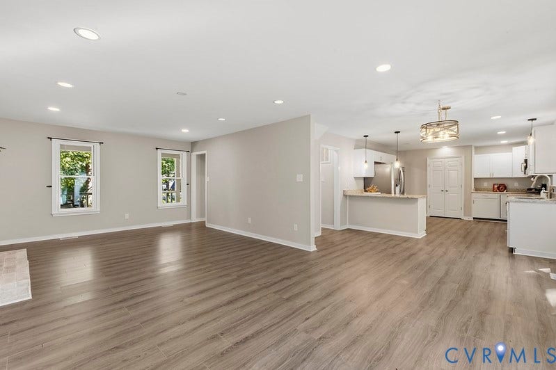9007 Chatham Grove Lane, Richmond, VA 23236 Spacious living area featuring wood-finish flooring, recessed lighting, and white trim