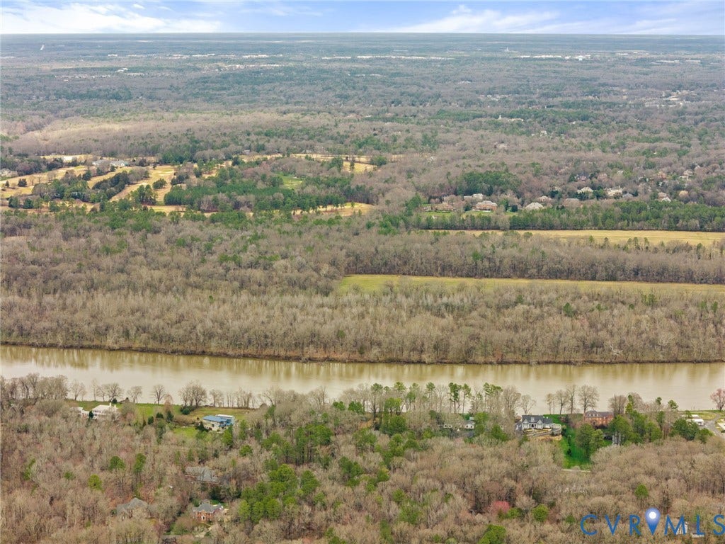Aerial perspective featuring a river, surrounding woodlands, and distant golf course