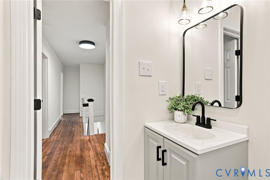 625 N 33rd Street, Chimborazo, Richmond, VA 23223 Modern bathroom featuring a floating vanity with white quartz countertop, matte black wall-mounted faucet, and integrated sink