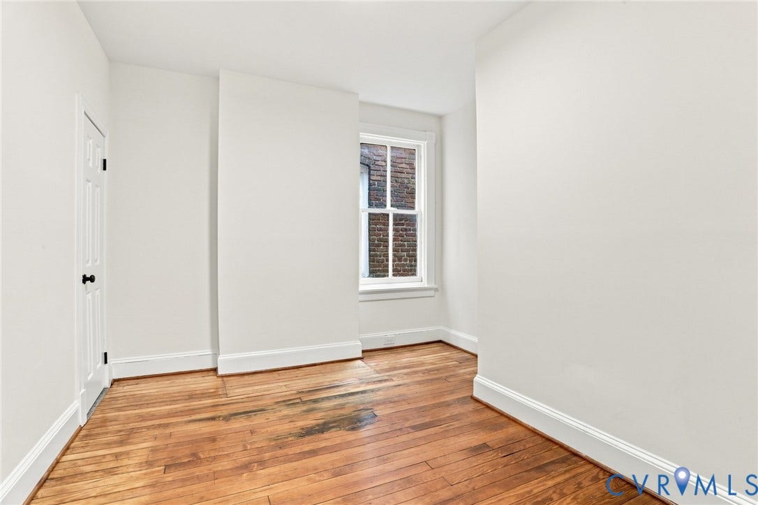 625 N 33rd Street, Chimborazo, Richmond, VA 23223 Bright corner bedroom featuring hardwood flooring, white painted walls, and abundant natural light from a multi-pane window