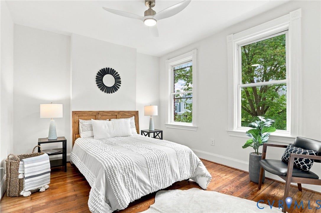 625 N 33rd Street, Chimborazo, Richmond, VA 23223 Hardwood flooring, white walls, two large windows, wood headboard, and a ceiling fan with integrated lighting