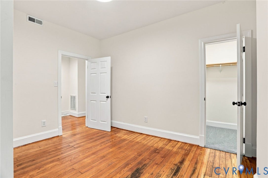 625 N 33rd Street, Chimborazo, Richmond, VA 23223 Hardwood flooring, painted walls, white trim, paneled doors with black hardware, and an overhead light fixture