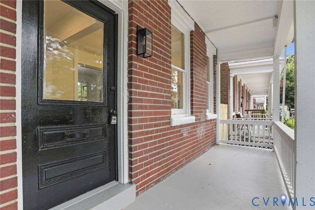 625 N 33rd Street, Chimborazo, Richmond, VA 23223 Brick exterior featuring a covered porch, white railing, and a black entryway door with a window panel