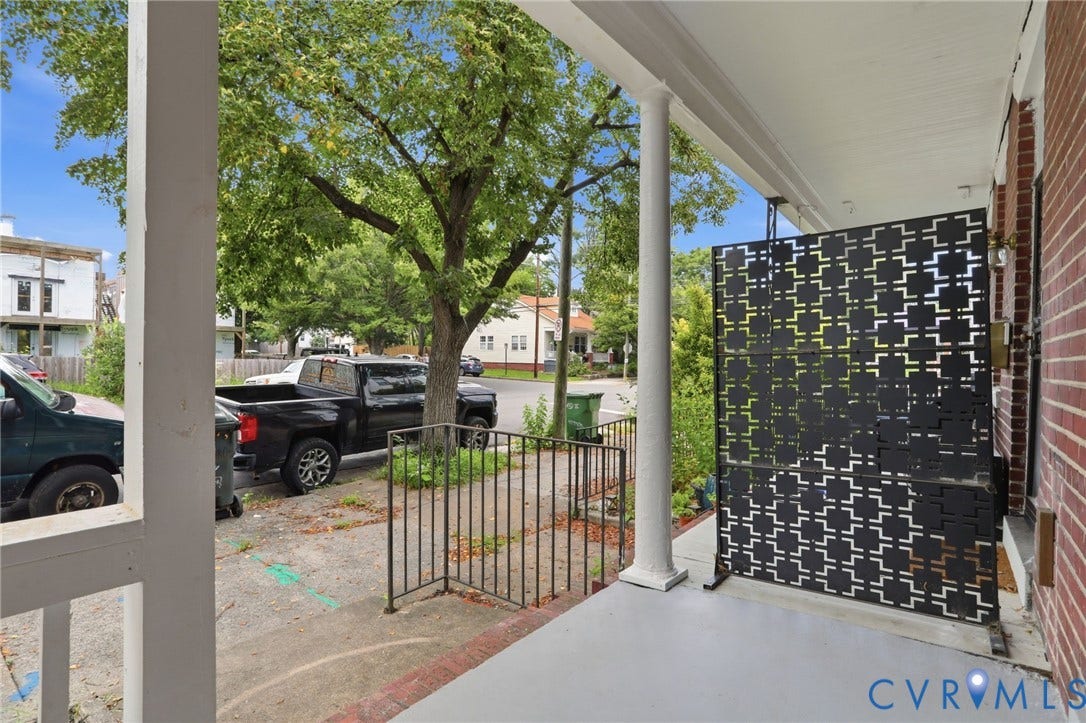 625 N 33rd Street, Chimborazo, Richmond, VA 23223 Front porch with white painted columns, a patterned privacy screen, and a brick exterior wall