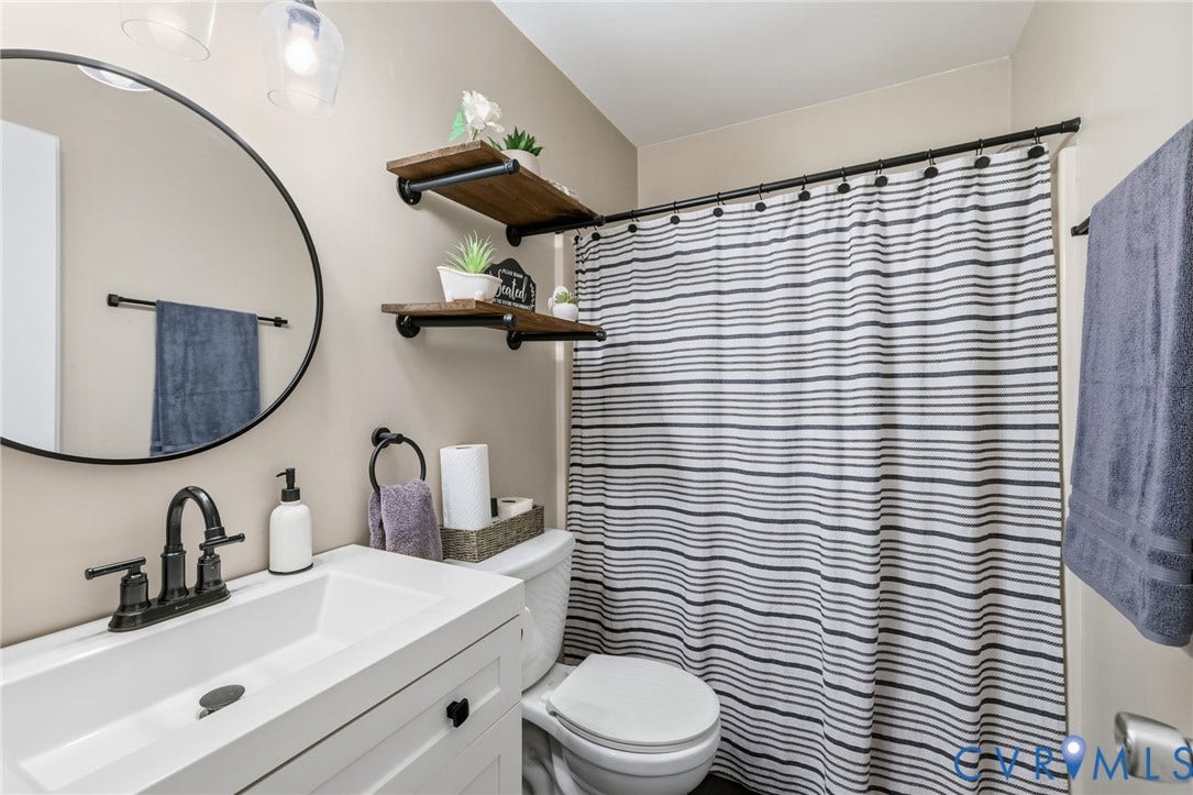 7306 Native Dancer Drive, Midlothian, VA 23112 White vanity with a single basin sink and a matte black faucet