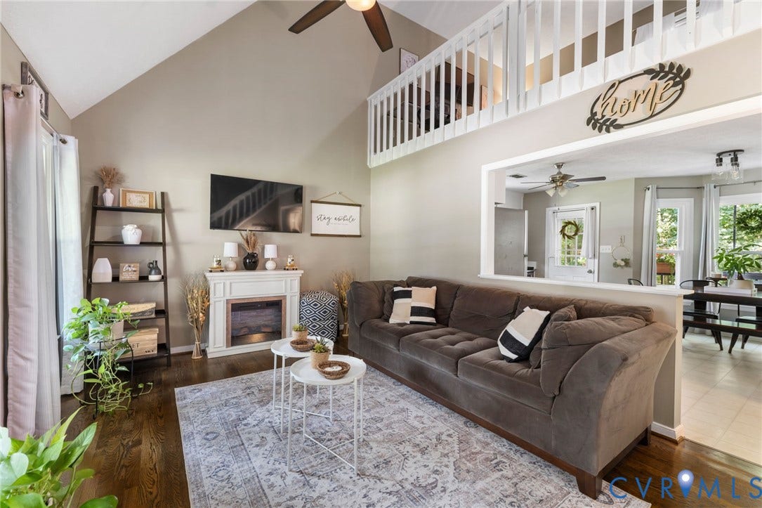 7306 Native Dancer Drive, Midlothian, VA 23112 Vaulted ceiling, wood-finish flooring, white fireplace, upper-level railing, and open-concept living space