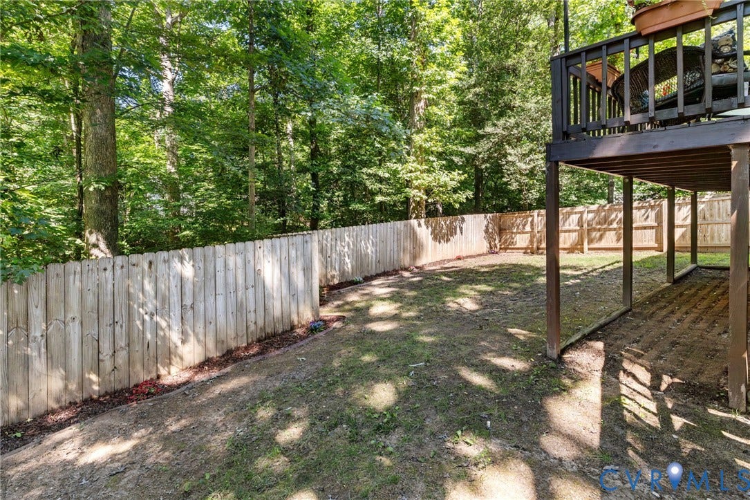 7306 Native Dancer Drive, Midlothian, VA 23112 Expansive backyard with a wood privacy fence and a multi-level wood deck
