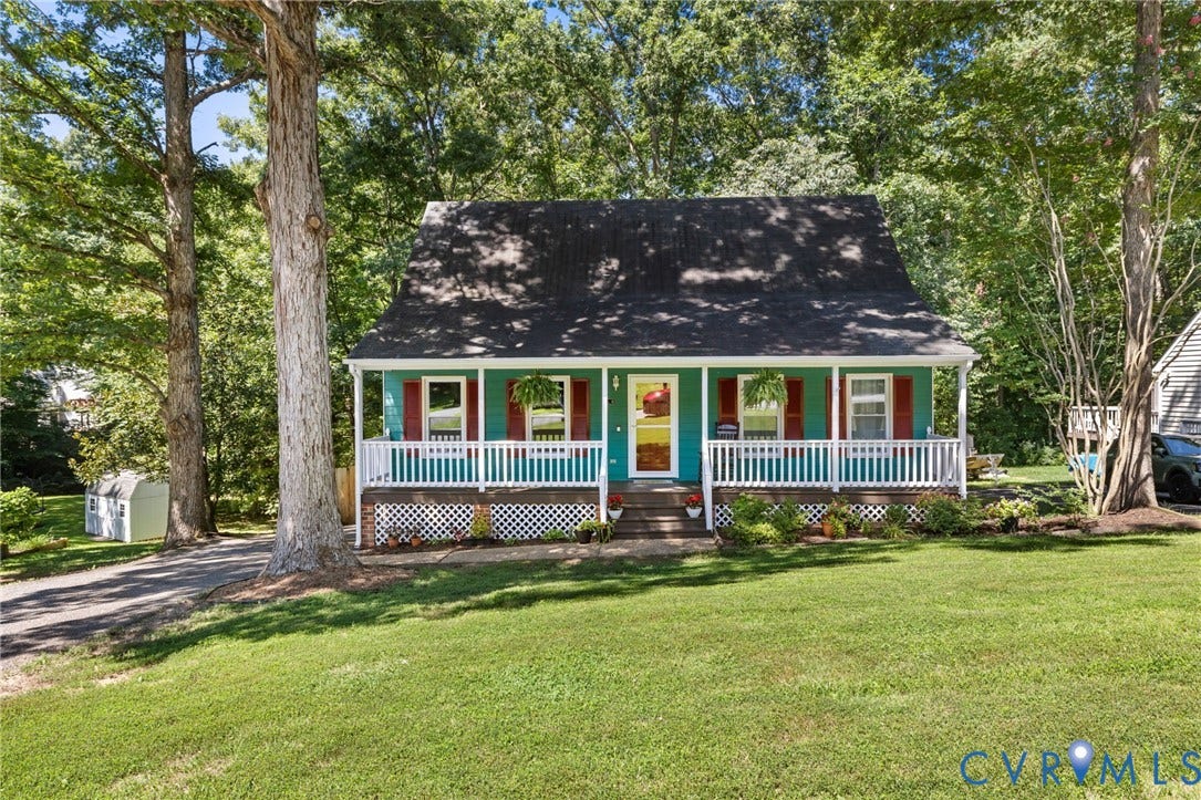 7306 Native Dancer Drive, Midlothian, VA 23112 Front exterior featuring a covered porch with white railings, a vibrant teal facade, and red window shutters