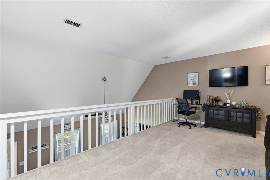 7306 Native Dancer Drive, Midlothian, VA 23112 Carpeted loft space featuring a white railing and neutral wall tones