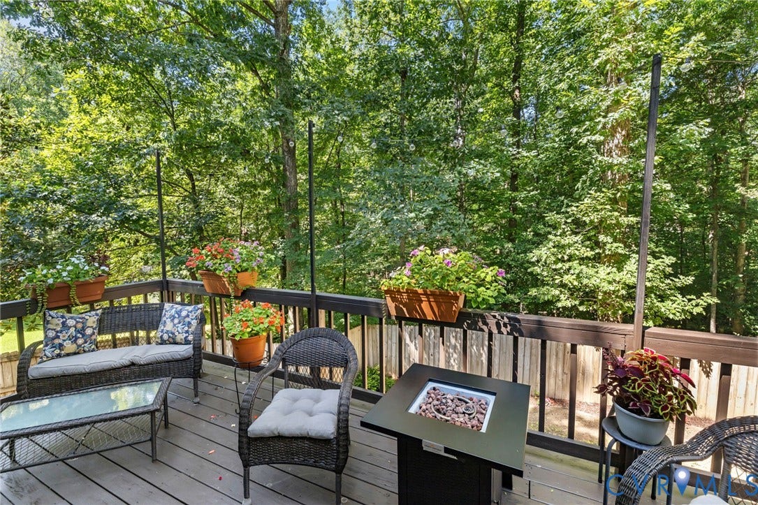 7306 Native Dancer Drive, Midlothian, VA 23112 Expansive outdoor deck with a wood railing and integrated fire pit