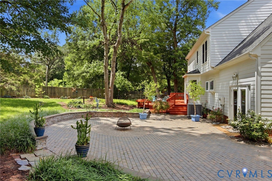 Expansive stone paver patio features a retaining wall, the perfect spot for marshmallow roast, s'mores anyone!