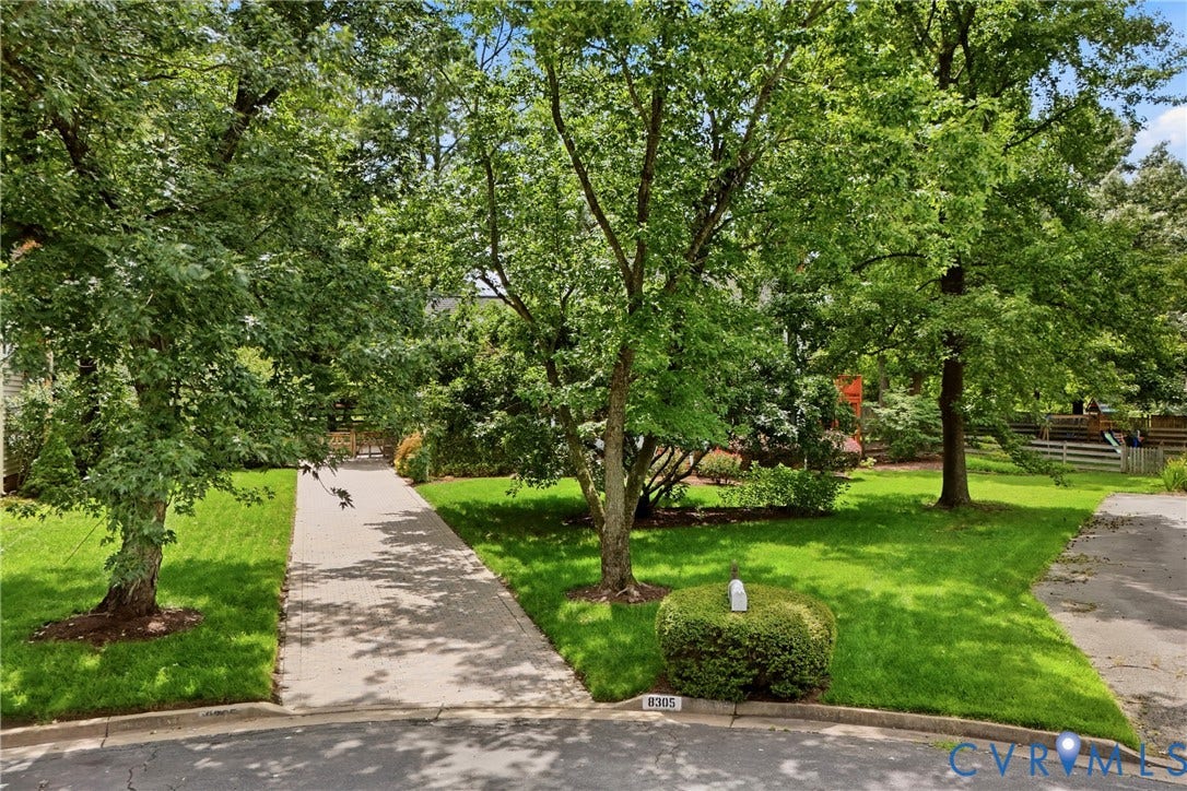 Mature trees at the entrance to your stone paver driveway!