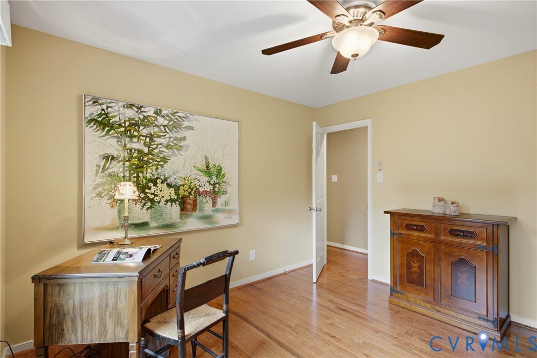 3rd Bedroom, Warm-toned walls complement wood-finish flooring throughout this room