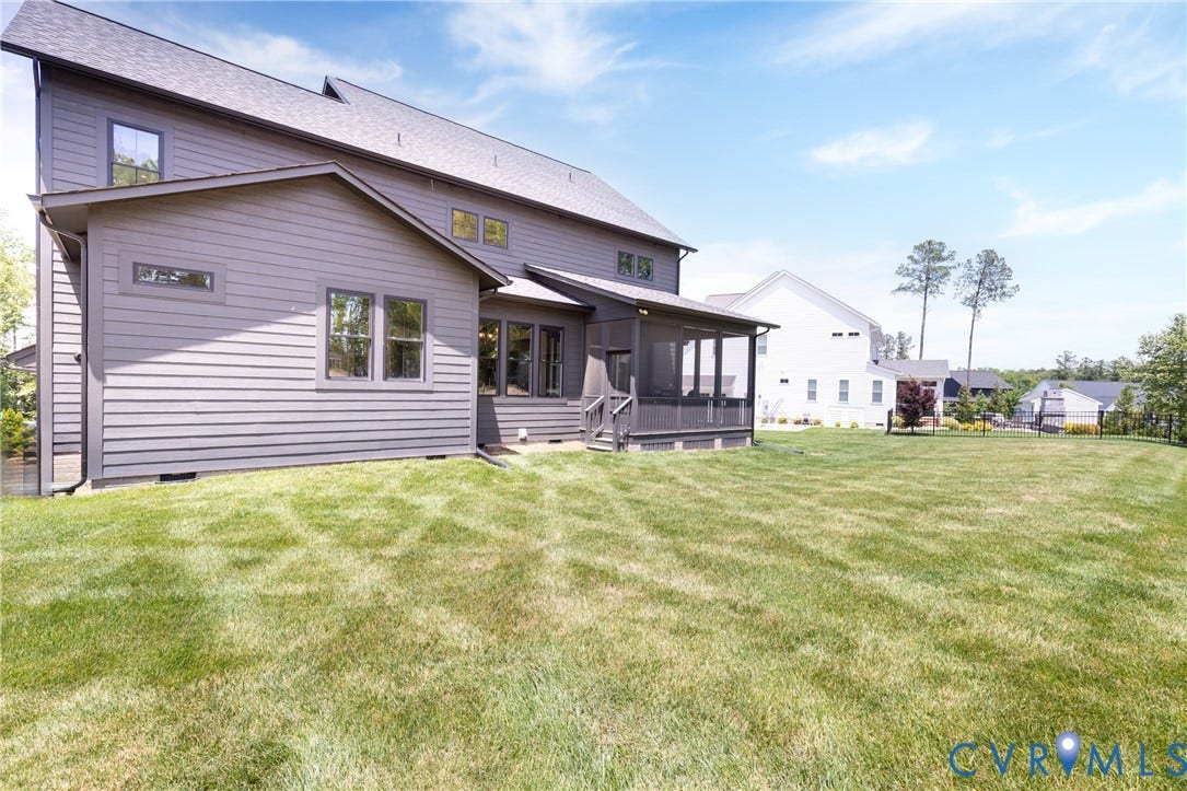4600 Otter Court, Moseley, VA 23120 Expansive green lawn bordering a modern home with gray siding