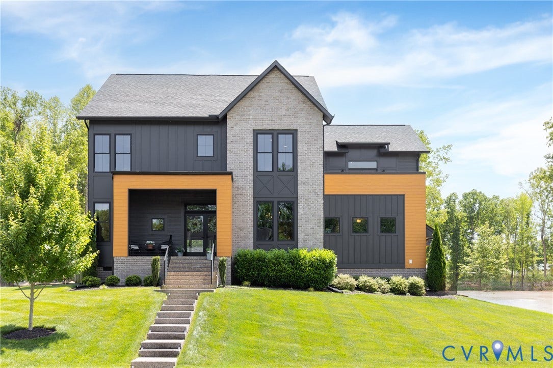 4600 Otter Court, Moseley, VA 23120 Contemporary exterior featuring a light gray brick facade, dark vertical siding, and warm wood-finish accents