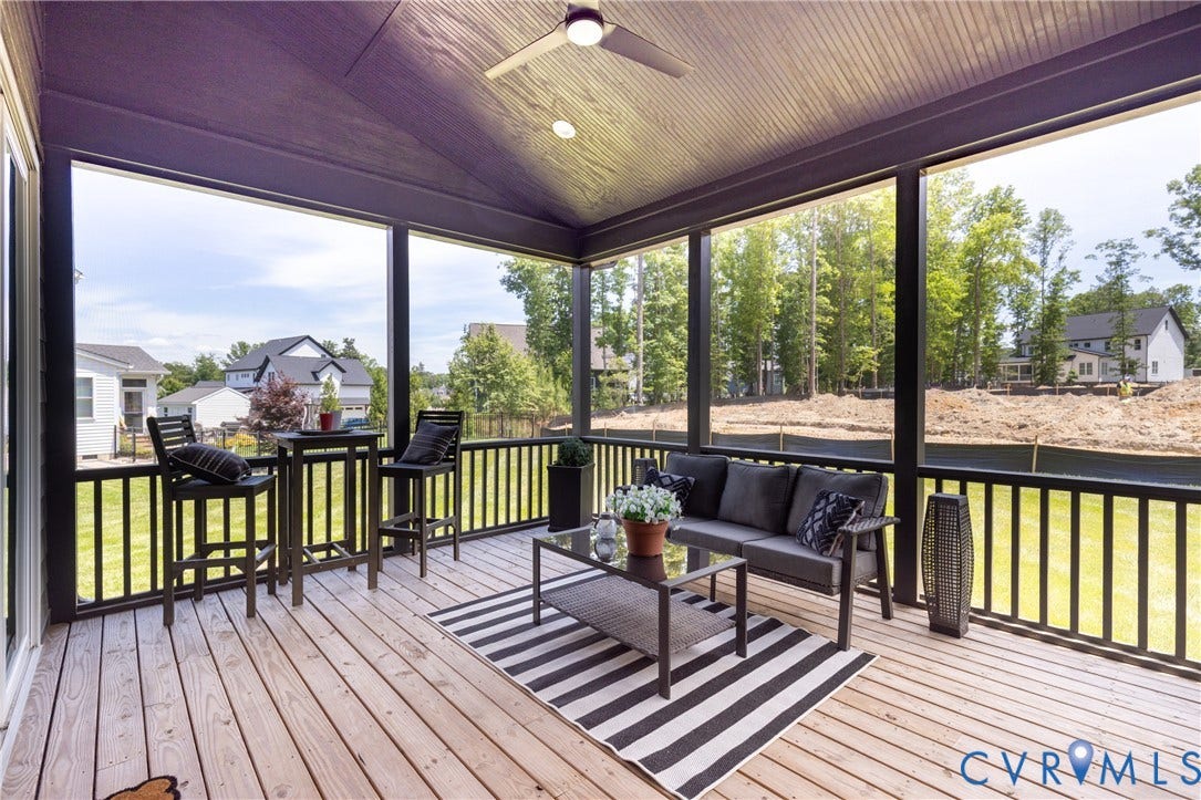4600 Otter Court, Moseley, VA 23120 Expansive screened-in porch featuring wood-finish flooring, a vaulted ceiling, and a ceiling fan with integrated lighting