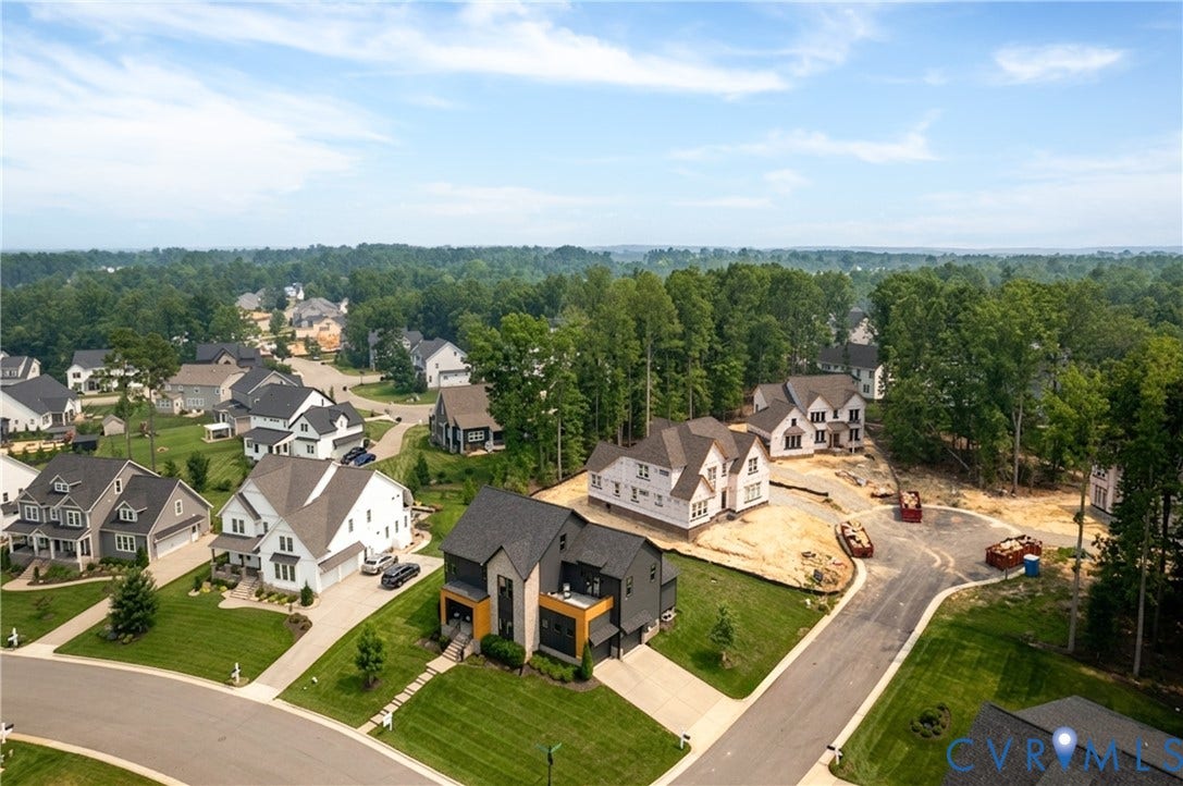 4600 Otter Court, Moseley, VA 23120 Aerial perspective showcasing a residential development with established homes and properties under construction