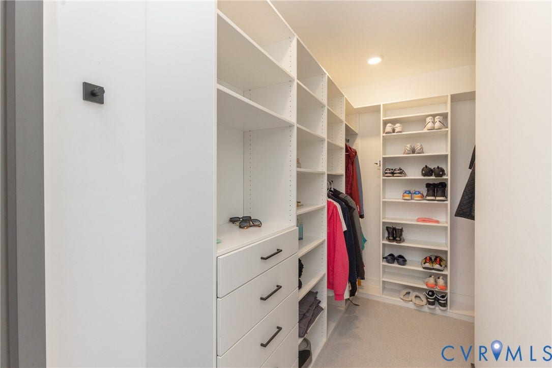 4600 Otter Court, Moseley, VA 23120 Walk-in closet featuring built-in white shelving, integrated drawers with dark hardware, and recessed lighting