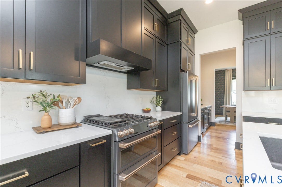 4600 Otter Court, Moseley, VA 23120 Gourmet kitchen featuring dark cabinetry with gold-tone hardware, white countertops, a gas range with a double oven, stainless steel appliances, and wood-finish flooring