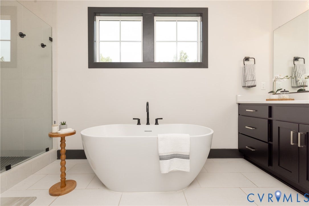 4600 Otter Court, Moseley, VA 23120 Freestanding soaking tub with a floor-mounted matte black faucet