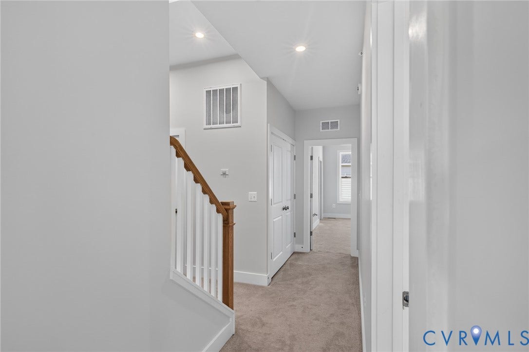 1509 Moore Street, #B, Richmond, VA 23220 Carpeted hallway with white interior doors, recessed lighting, and a staircase featuring wood-finish handrails