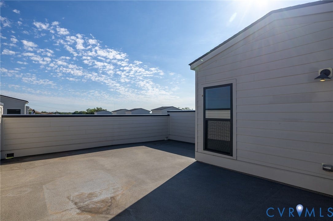 1509 Moore Street, #B, Richmond, VA 23220 Expansive rooftop patio with a protective perimeter wall, textured flooring, and exterior lighting