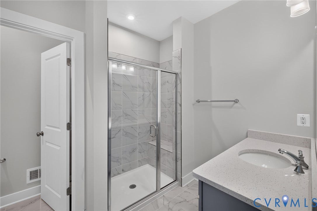 1509 Moore Street, #B, Richmond, VA 23220 Glass-enclosed shower with marble-finish tile surround and integrated bench
