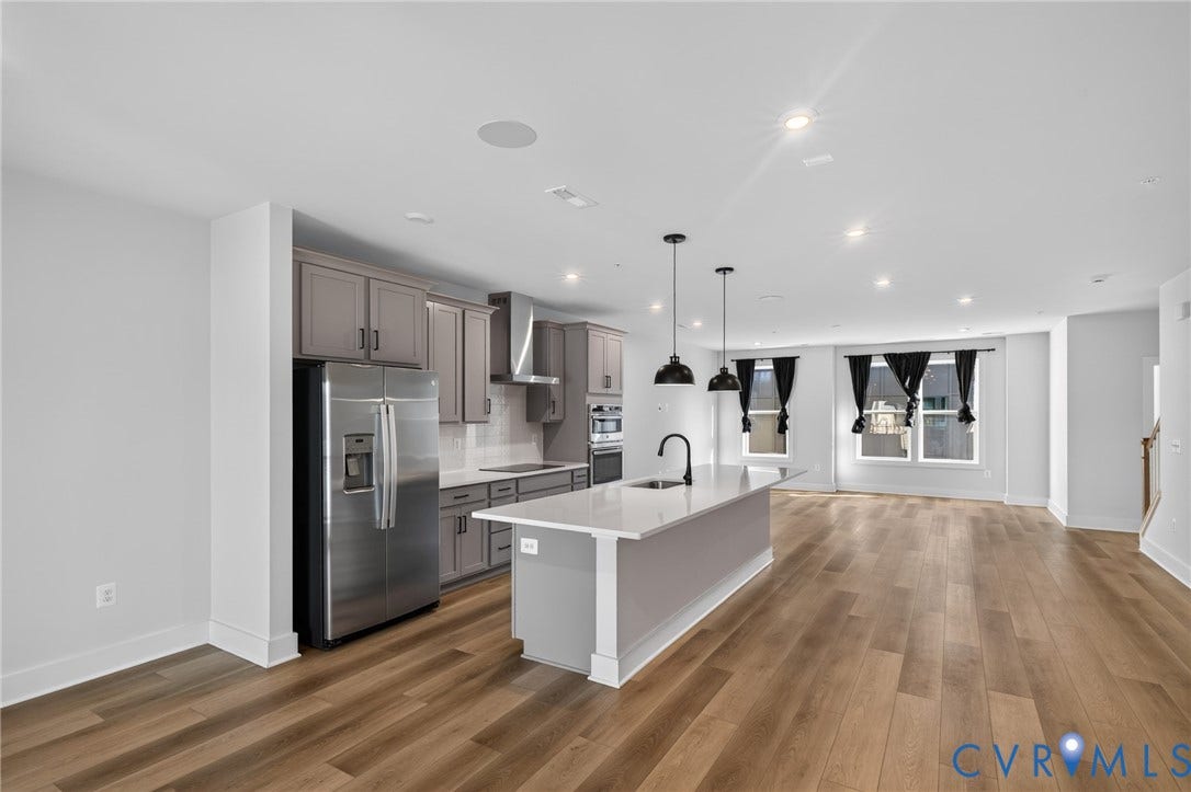 1509 Moore Street, #B, Richmond, VA 23220 Kitchen featuring stainless steel appliances, a center island with pendant lighting, and light wood-finish flooring