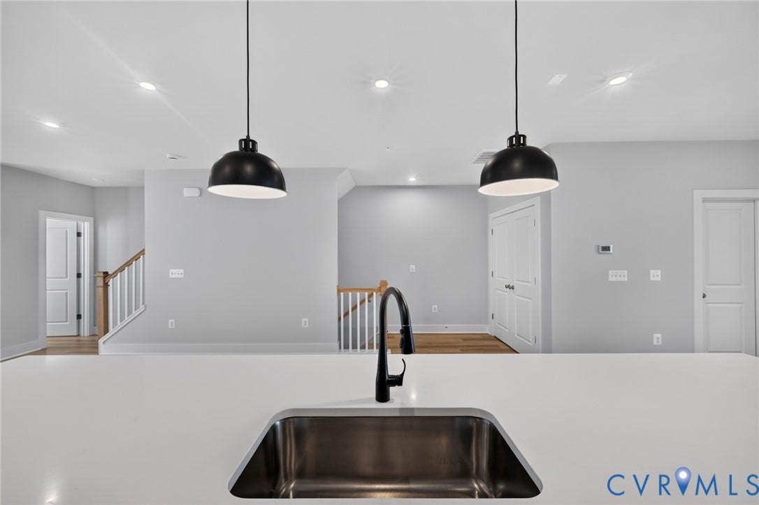 1509 Moore Street, #B, Richmond, VA 23220 Large kitchen island with an undermount stainless steel sink, a matte black gooseneck faucet, and two black pendant lights