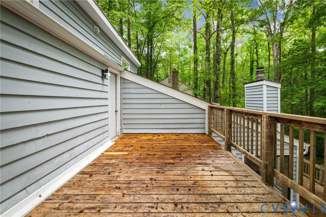 2903 Fox Chase Drive, Huntsbridge, Midlothian, VA 23112 Spacious composite deck featuring warm wood-finish decking, white horizontal vinyl siding, and wooden railings with turned balusters