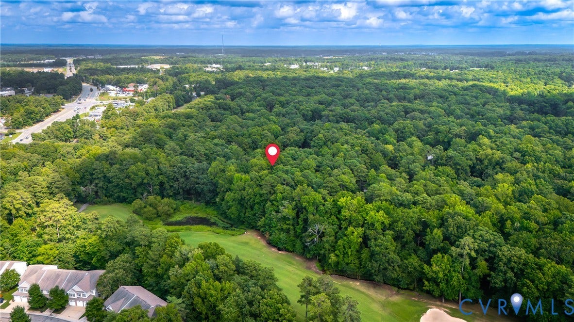 2903 Fox Chase Drive, Huntsbridge, Midlothian, VA 23112 Expansive wooded property featuring mature tree canopy, rolling terrain, and open lawn areas