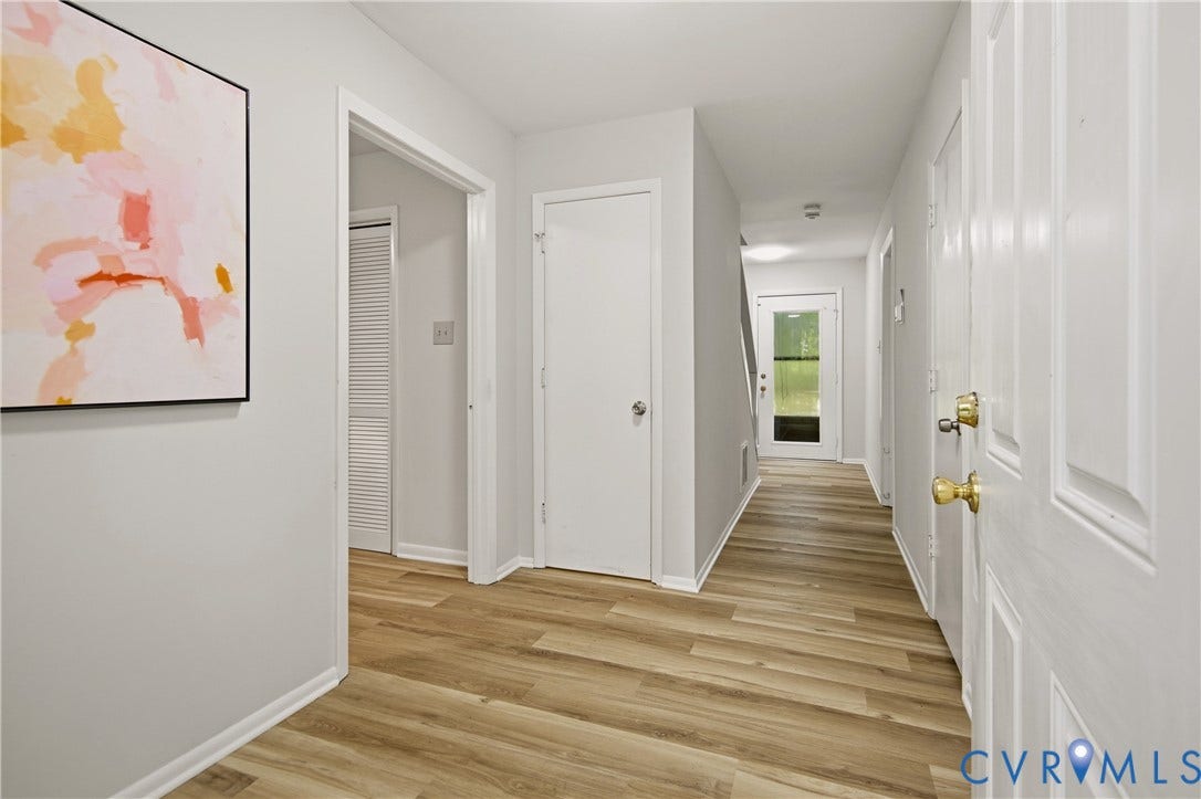 2903 Fox Chase Drive, Huntsbridge, Midlothian, VA 23112 Spacious hallway featuring wood-finish flooring, light grey wall paint, white trim, and multiple white paneled doors