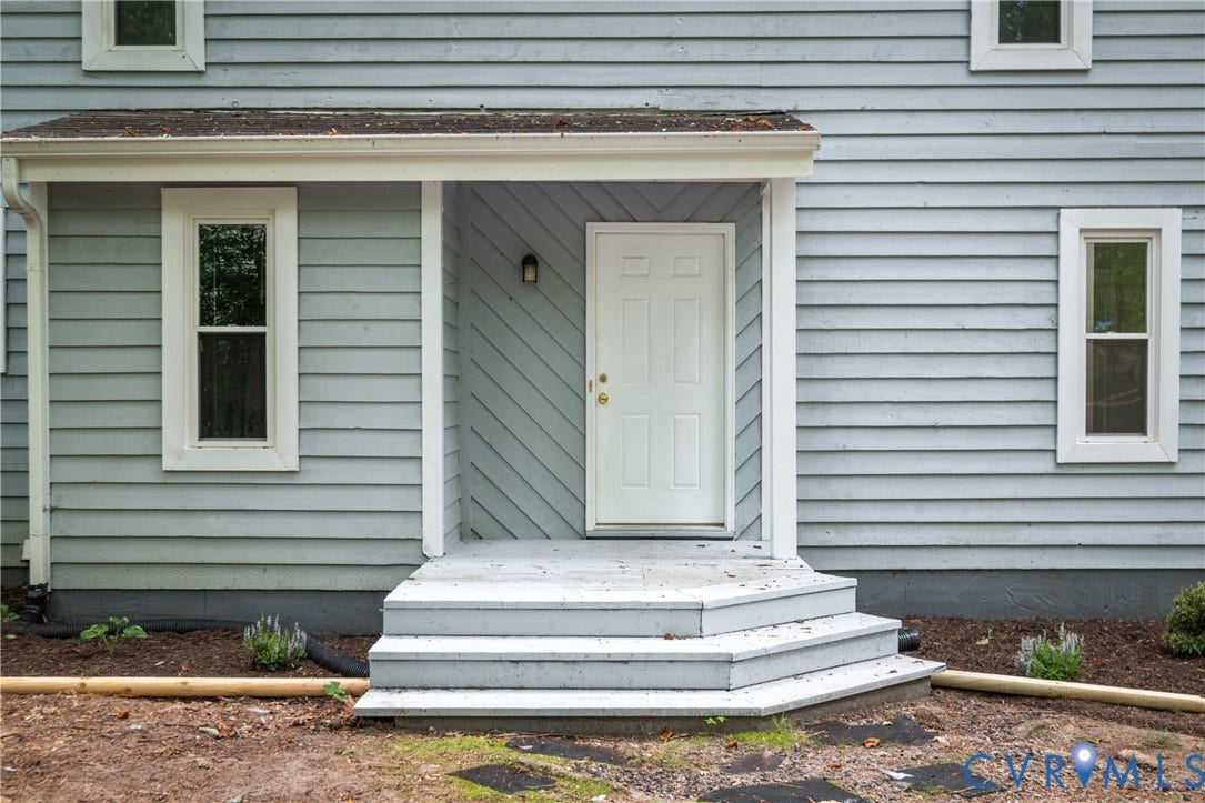 2903 Fox Chase Drive, Huntsbridge, Midlothian, VA 23112 Front porch entry with a paneled door, exterior lighting, and multi-level steps