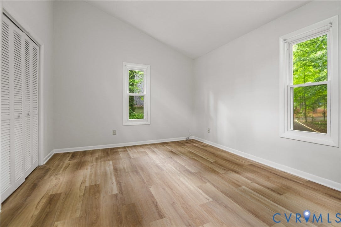 2903 Fox Chase Drive, Huntsbridge, Midlothian, VA 23112 Room with wood-finish flooring, two windows, and a white louvered bifold closet door