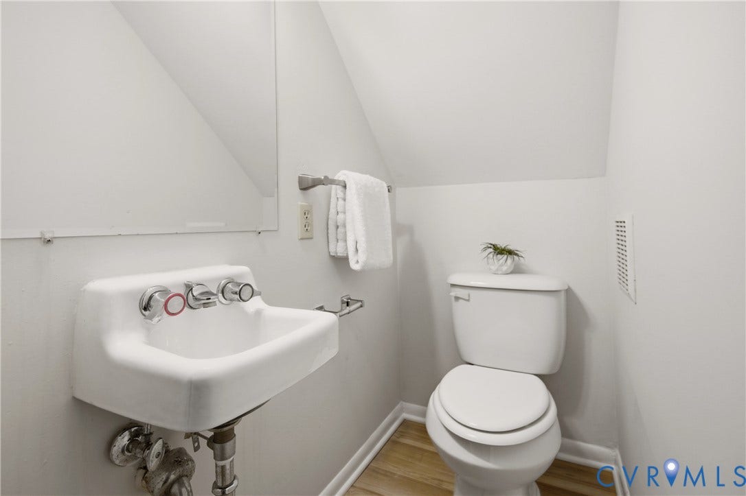 2903 Fox Chase Drive, Huntsbridge, Midlothian, VA 23112 Compact bathroom featuring a wall-mounted porcelain sink with chrome fixtures and a white toilet