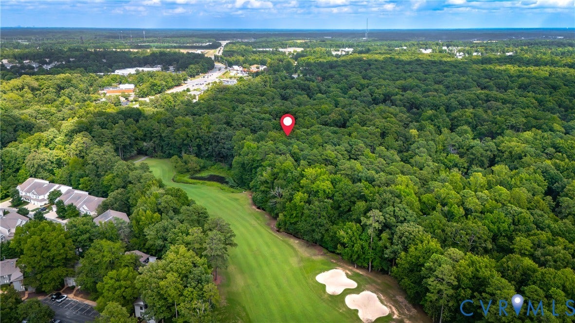 2903 Fox Chase Drive, Huntsbridge, Midlothian, VA 23112 Aerial view showcasing expansive grounds with manicured fairway-style lawn, mature tree-lined perimeter, and integrated golf course amenities including sand bunkers