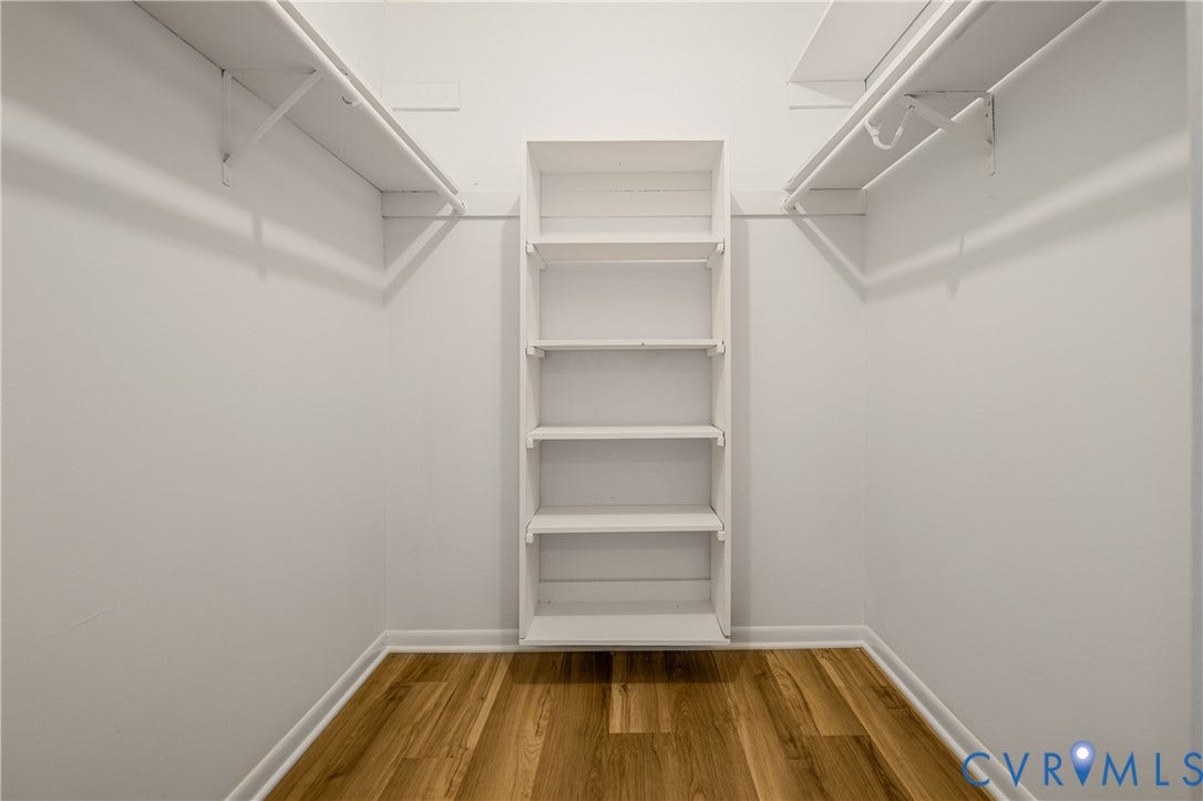 2903 Fox Chase Drive, Huntsbridge, Midlothian, VA 23112 Spacious walk-in closet featuring built-in shelving with five fixed shelves, white painted finishes, and polished chrome hanging rods on both sides