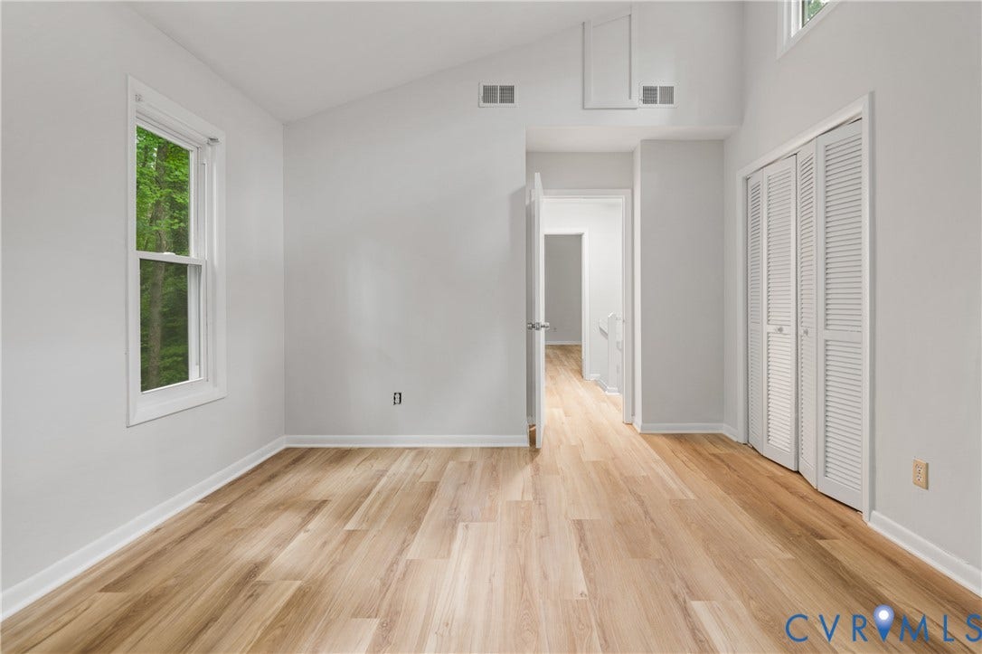 2903 Fox Chase Drive, Huntsbridge, Midlothian, VA 23112 Vaulted ceiling room featuring wood-finish flooring, a double-hung window, white louvered bifold closet doors, and recessed air vents