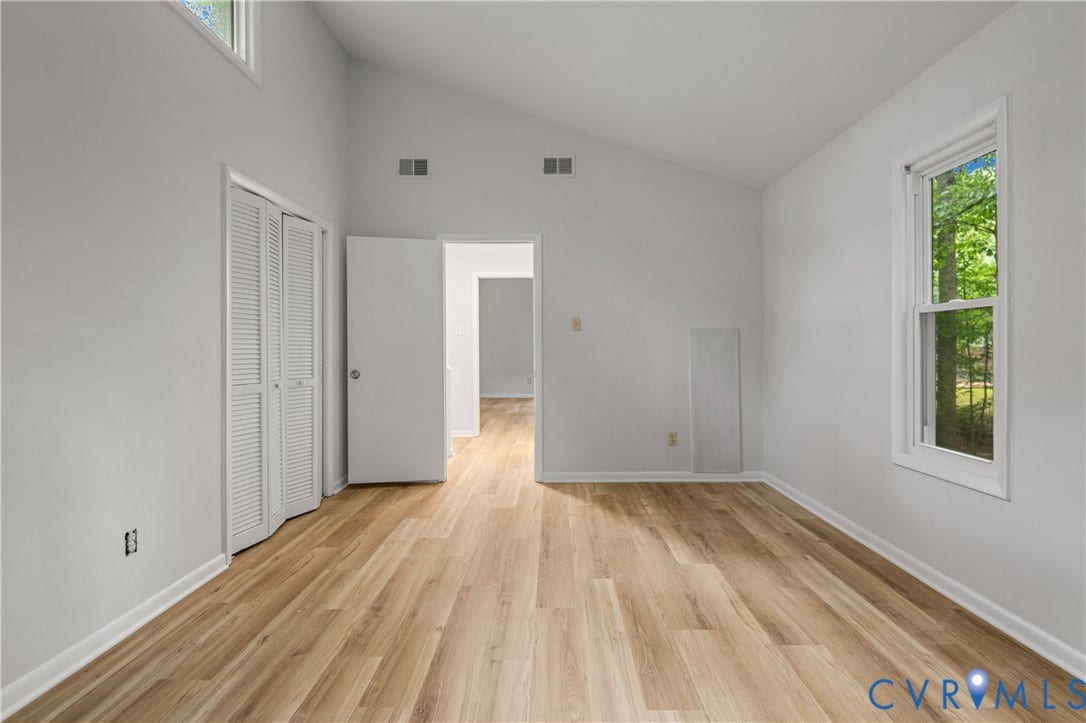 2903 Fox Chase Drive, Huntsbridge, Midlothian, VA 23112 Spacious room featuring wood-finish flooring, vaulted ceilings, and a large window