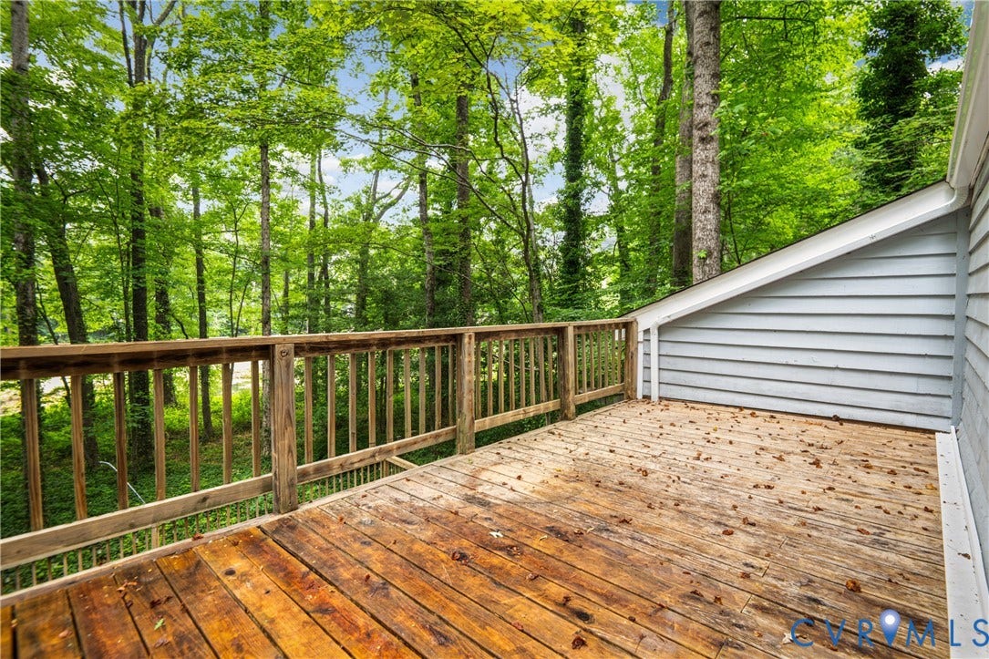 2903 Fox Chase Drive, Huntsbridge, Midlothian, VA 23112 Wood deck with natural wood railing, light blue horizontal siding, and lush green tree canopy