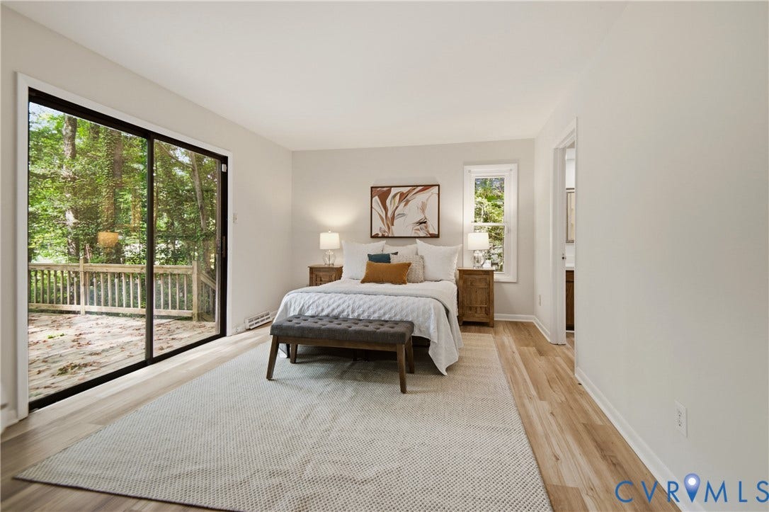2903 Fox Chase Drive, Huntsbridge, Midlothian, VA 23112 Spacious bedroom featuring wood-finish flooring, a large sliding glass door with exterior deck access, and a secondary window