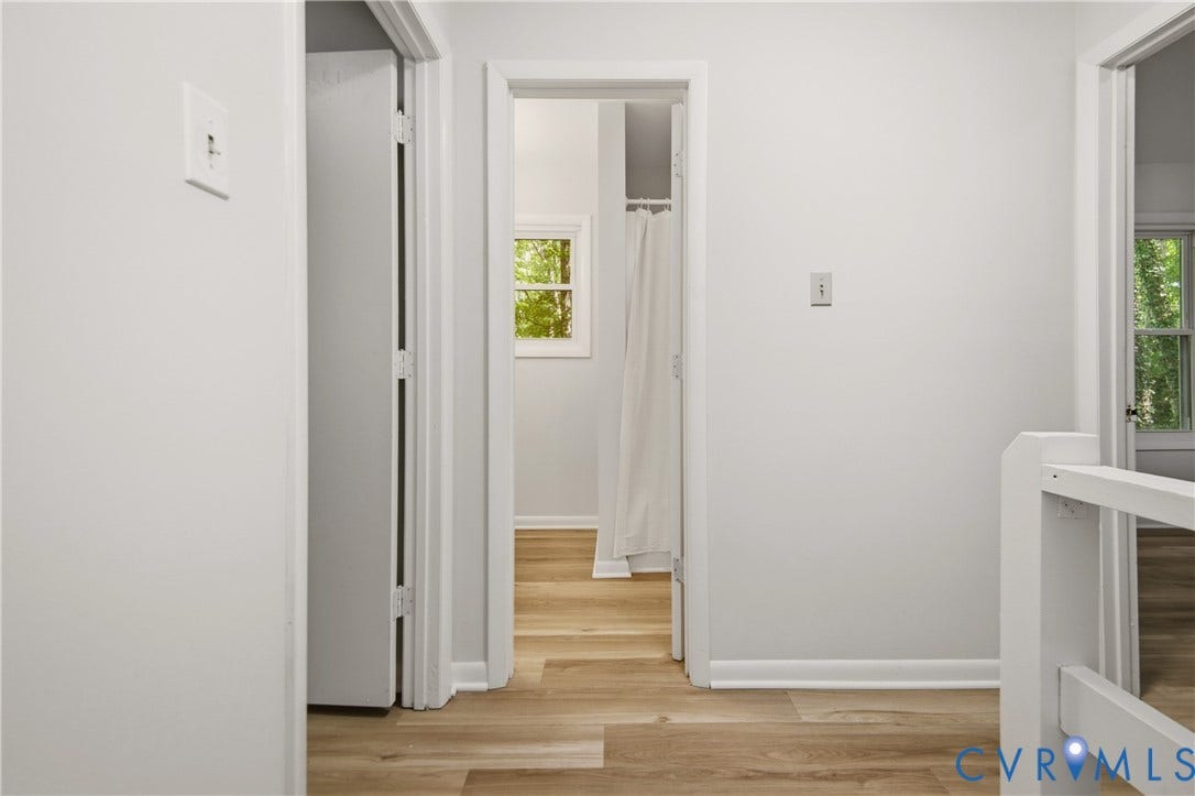 2903 Fox Chase Drive, Huntsbridge, Midlothian, VA 23112 Bright hallway featuring wood-finish flooring, clean white walls, and multiple doorways with white trim