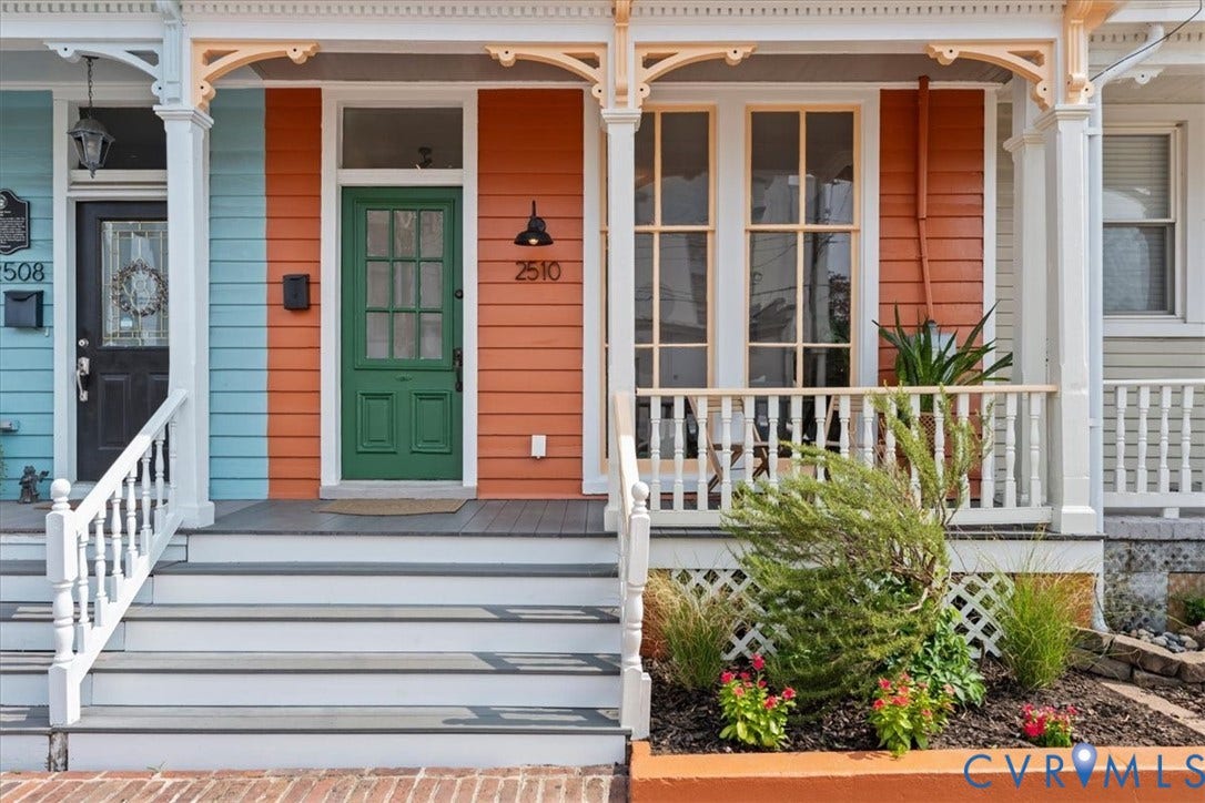 2510 E Leigh Street, Church Hill, Richmond, VA 23223 Vibrant exterior with orange and blue siding, white railings, and a green entry door