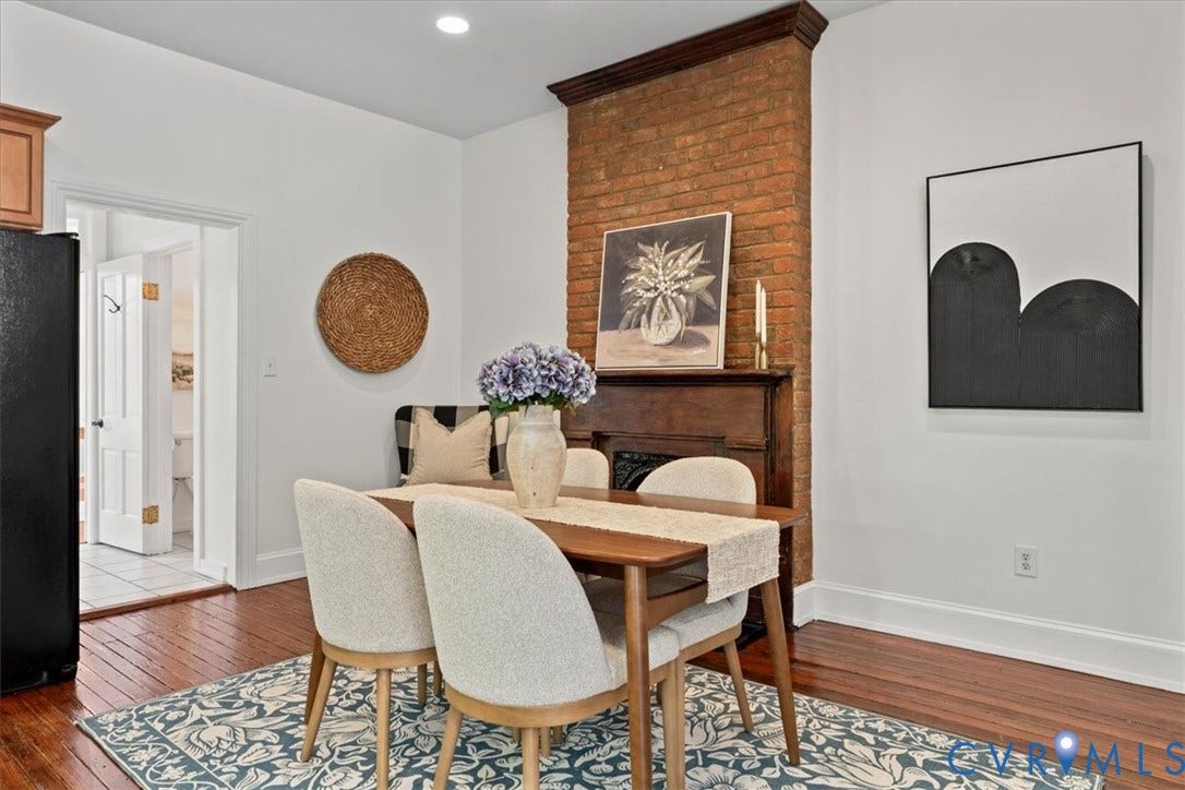2510 E Leigh Street, Church Hill, Richmond, VA 23223 Exposed brick accent wall, wood-finish flooring, white walls, recessed ceiling lighting, and a dark wood mantel