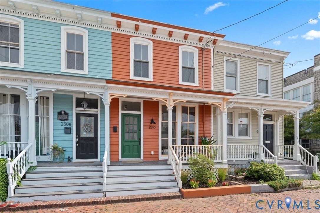 2510 E Leigh Street, Church Hill, Richmond, VA 23223 Vibrant exterior showcasing varied siding colors, white trim, decorative porch railings, and individual front doors with transom windows