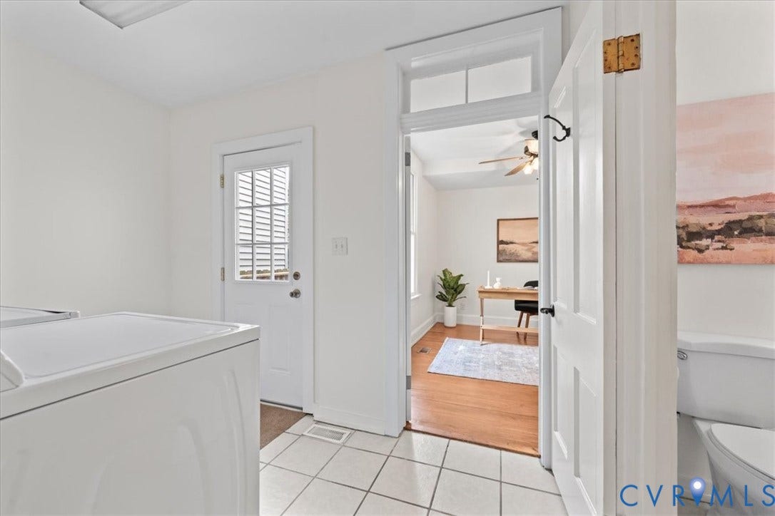 2510 E Leigh Street, Church Hill, Richmond, VA 23223 White tiled flooring, white painted walls, and a white paneled door with window inserts