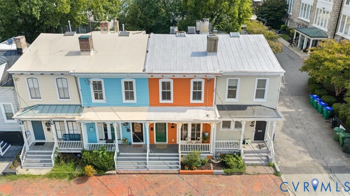 2510 E Leigh Street, Church Hill, Richmond, VA 23223 Colorful rowhouse facade with covered front porch, white railings, and brick walkway