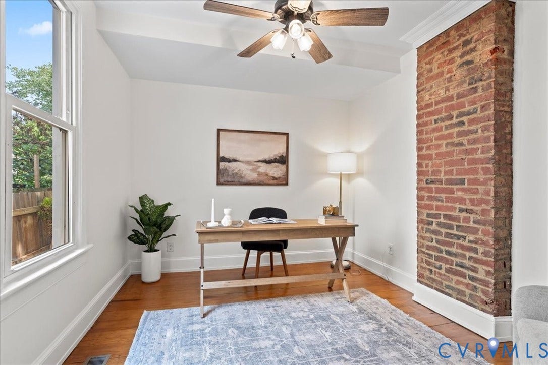 2510 E Leigh Street, Church Hill, Richmond, VA 23223 Hardwood flooring, exposed brick architectural feature, ceiling fan, white trim, and a large window